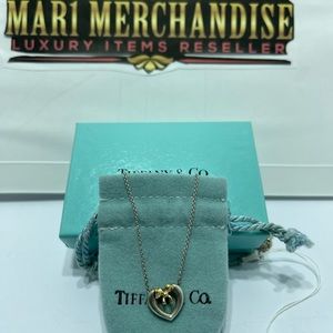 Tiffany and Co . Sterling Silver necklace heart with gold ribbon.